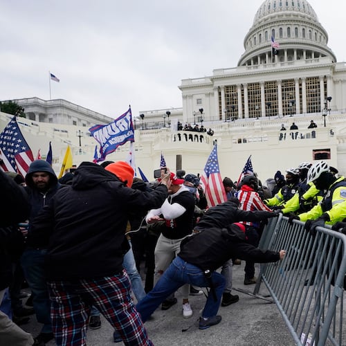 FILE - Violent insurrections loyal to President Donald Trump break through a police barrier at the Capitol in Washington on Jan. 6, 2021. (AP Photo/Julio Cortez, File)