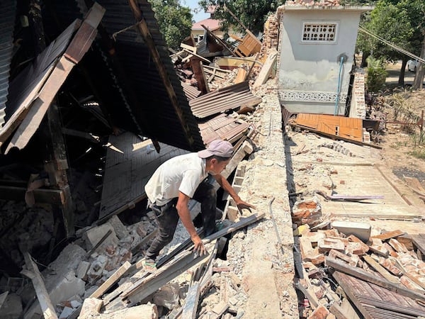 A person goes through rubble at a Buddhist monastery building that has collapsed following an earthquake in Naypyitaw, Myanmar Sunday, March 30, 2025. (AP Photo/Aung Shine Oo)