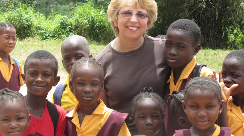 This Oct. 7, 2013 photo provided by Jeremy Writebol show his mother, Nancy Writebol, with children in Liberia. Writebol is one of two Americans working for a missionary group in Liberia that have been diagnosed with Ebola. Plans are underway to bring back the two Americans from Africa for treatment. (AP Photo/Courtesy Jeremy Writebol) This Oct. 7, 2013 photo provided by Jeremy Writebol show his mother, Nancy Writebol, with children in Liberia. Writebol is one of two Americans working for a missionary group in Liberia that have been diagnosed with Ebola. Plans are underway to bring back the two Americans from Africa for treatment. AP/Courtesy Jeremy Writebol