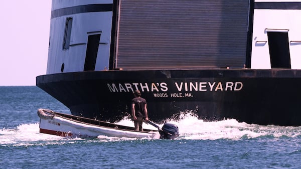 A man navigates the wake behind the Martha's Vineyard Ferry, Monday, May 12, 2025, in Vineyard Haven, Mass. (AP Photo/Charles Krupa)