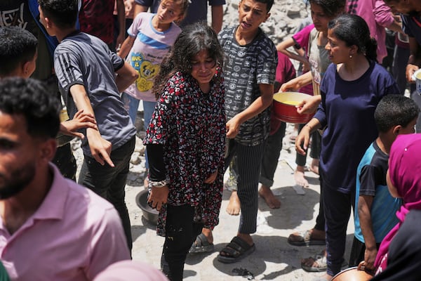 Palestinians line up for donated food at a community kitchen in Jabalia, in the northern Gaza Strip, on Monday, May 19, 2025. (AP Photo/Jehad Alshrafi)