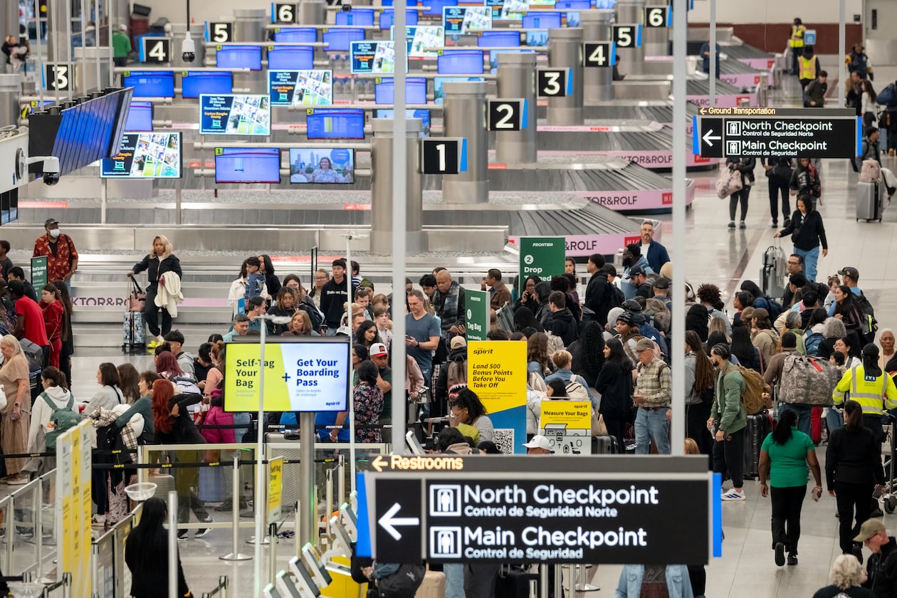 A line of passengers waits at the Frontier Airlines ticketing counter at Hartsfield-Jackson Atlanta International Airport on Friday, Nov. 21, 2025. (Ben Hendren for the AJC)