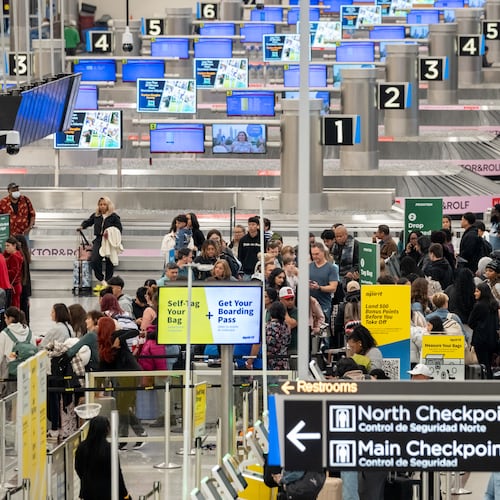 A line of passengers waits at the Frontier Airlines ticketing counter at Hartsfield-Jackson Atlanta International Airport on Friday, Nov. 21, 2025. (Ben Hendren for the AJC)