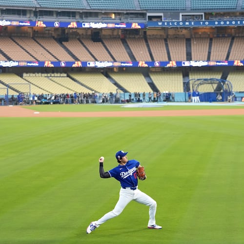 Los Angeles Dodgers' Shohei Ohtani works out ahead of Game 3 of the 2025 World Series against the Toronto Blue Jays in Los Angeles, Sunday, Oct. 26, 2025. (AP Photo/Ashley Landis)