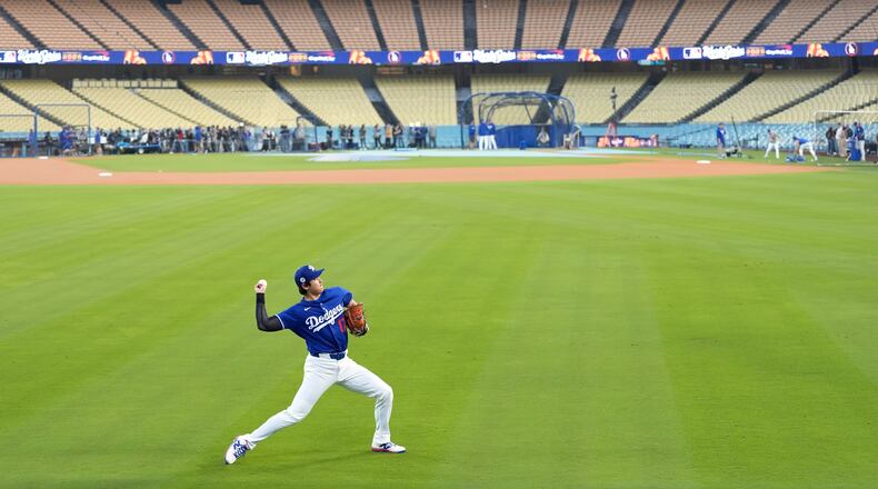 Los Angeles Dodgers' Shohei Ohtani works out ahead of Game 3 of the 2025 World Series against the Toronto Blue Jays in Los Angeles, Sunday, Oct. 26, 2025. (AP Photo/Ashley Landis)