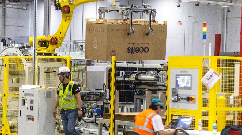Workers fine-tune the packaging and shipment portion of the automated system at the Qcells module production facility in Cartersville on Tuesday, April 2, 2024. (Steve Schaefer/steve.schaefer@ajc.com)