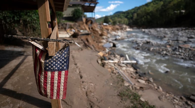 A tattered American flag is seen on a property amongst flood damage in the aftermath of Hurricane Helene on October 2, 2024 in Chimney Rock, North Carolina. (Courtesy of Sean Rayford/Getty Images)