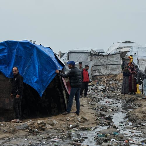 Displaced Palestinians repair their tents at a tent camp on the beach after a stormy weather in Gaza City, Wednesday, Dec. 10, 2025. (AP Photo/Jehad Alshrafi)