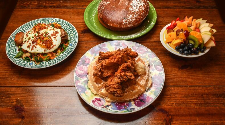 220805 Johns Creek, Ga: Some of the items offered at Hen Mother Cookhouse (from left): Market Hash, Fluffy Buttermilk Pancakes (center top), Chicken & Waffle (center bottom) and Fruit Cup. Photo for Culinary Journey series on Soraya Khoury, co-owner of Hen Mother Cookhouse in Johns Creek, Ga. Photo taken Friday August 5, 2022. AAJC082122SLAATLCULINARYJOURNEY (CHRIS HUNT FOR THE ATLANTA JOURNAL-CONSTITUTION)