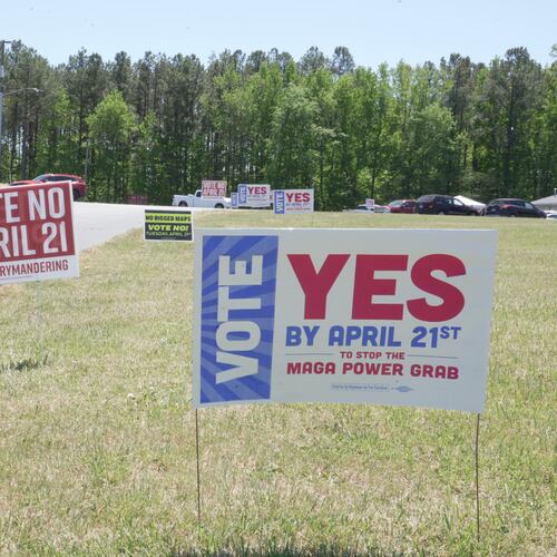 A truck passes political signs outside a polling place at Good Shepherd Catholic Church in South Hill, Va., on Tuesday, April 21, 2026. (AP Photo/Allen G. Breed)