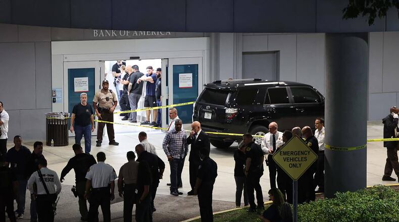 Police officers and other officials stand outside the Ryder Trauma Center after a Miami-Dade police officer was shot Monday. (Alie Skowronski/Miami Herald/TNS)