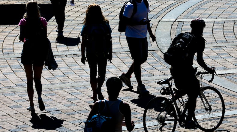 August 25, 2016 Atlanta: Taking in a sunny day on campus, some Georgia Tech students walked to class, others rode along the bricks of the Georgia Tech Plaza in front of the Kessler Campanile outside the Student Center Commons on Thursday, Aug. 25, 2016. Channel 2 Meteorologist Brad Nitz says Friday will be another dry day Partly cloudy with a high of 91 and a low of 71. JOHN SPINK /JSPINK@AJC.COM