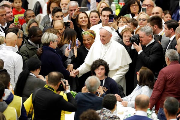 FILE - Pope Francis greets people as he arrives at a lunch for the poor, homeless, migrants and unemployed, at the Vatican, Sunday, Nov. 18, 2018. (AP Photo/Andrew Medichini, file)