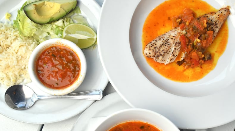 Eddie Hernandez’s Salsa Criolla Colombia (center) is flavorful without tasting spicy-hot. Here, it is shown with rice, avocado and lime (left) and tilapia (right). (Styling by Eddie Hernandez / Chris Hunt for The Atlanta Journal-Constitution)