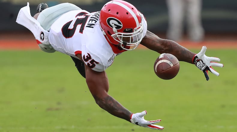 November 2, 2019 Jacksonville: Georgia tailback Brian Herrien makes a circus catch for a long first down gain against Florida during the third quarter in a NCAA college football game on Saturday, November 2, 2019, in Jacksonville.   Curtis Compton/ccompton@ajc.com