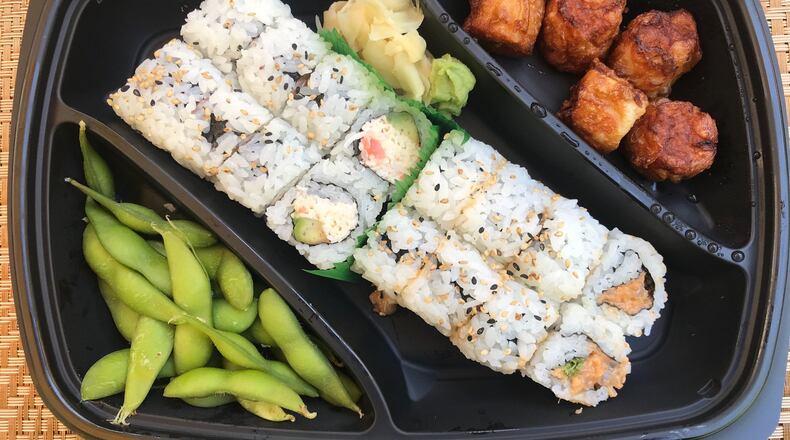 The rice bowl family meal includes four rice bowls along with five fried shumai, edamame, a seafood roll, spicy tuna roll, fried rice and miso soup. Pictured (from left) are the edamame, seafood roll, spicy tuna roll and shumai.