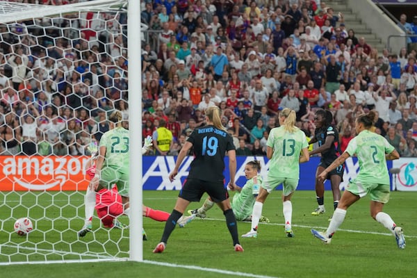 England's Michelle Agyemang, second right, scores her side's opening goal during the Women's Euro 2025 semifinals soccer match between England and Italy at Stade de Geneve in Geneva, Switzerland, Tuesday, July 22, 2025. (AP Photo/Martin Meissner)