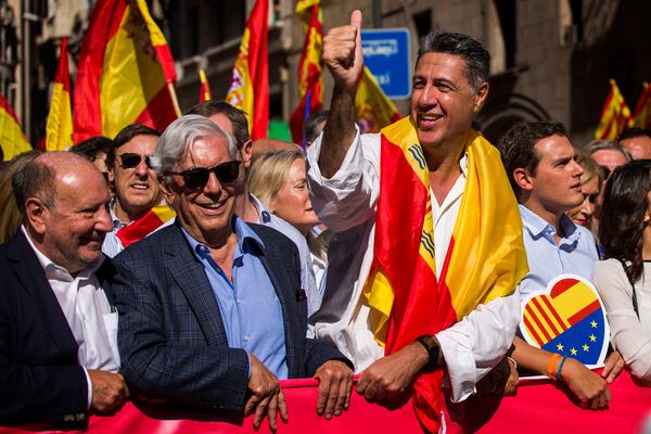 FILE - Nobel laureate Mario Vargas Llosa, second from left, stands next to Popular Party leader in Catalonia Xavier Garcia Albiol, right, as they lead a march to protest the Catalan government's push for secession from the rest of Spain in downtown Barcelona, Spain, Oct. 8, 2017. (AP Photo/Emilio Morenatti, File)