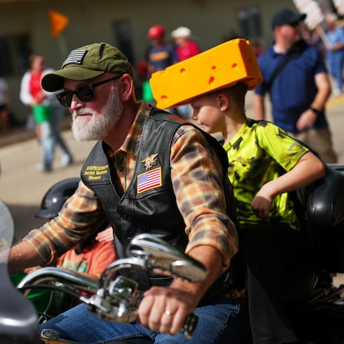Rep. Derrick Van Orden, R-Wis., a candidate for Wisconsin's 3rd Congressional district, rides a motorcycle with his grandson in a Labor Day parade, Monday, Sept. 7, 2026, in Readstown, Wis. (AP Photo/Ellen Schmidt)
