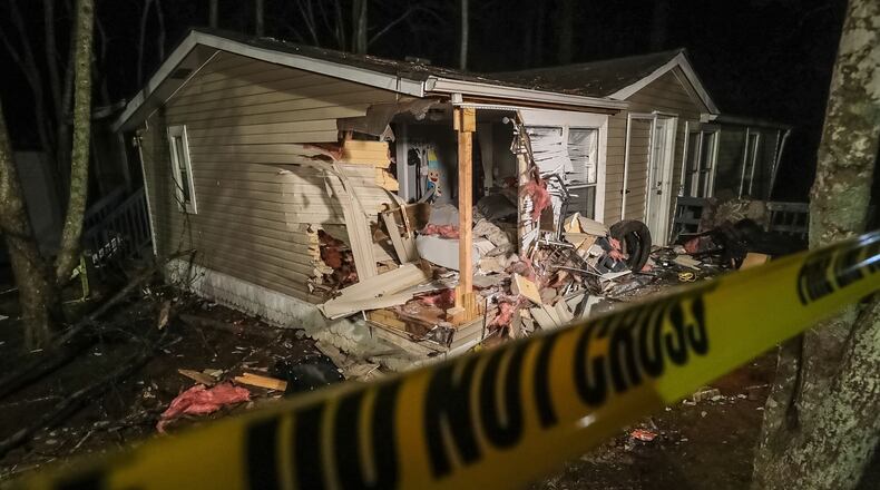 A man was killed and three people were injured Sunday after a car crashed into a mobile home in Gwinnett County, police said.