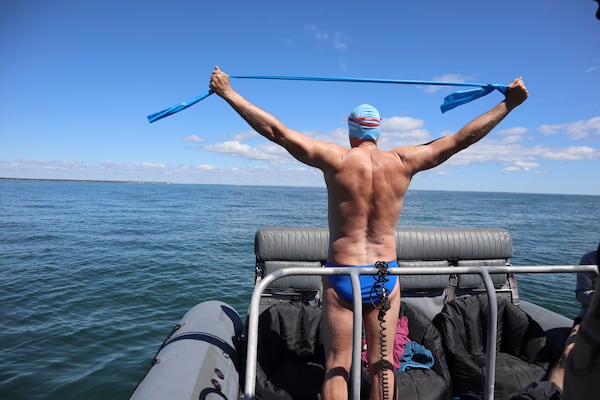 British South African endurance swimmer Lewis Pugh stretches before entering the water to complete his 12-day 62-mile (100 kilometer) swim around the island of Martha's Vineyard, Mass., ahead of the 50th anniversary of the first blockbuster film "Jaws"' release, Monday, May 26, 2025. (AP Photo/Leah Willingham)