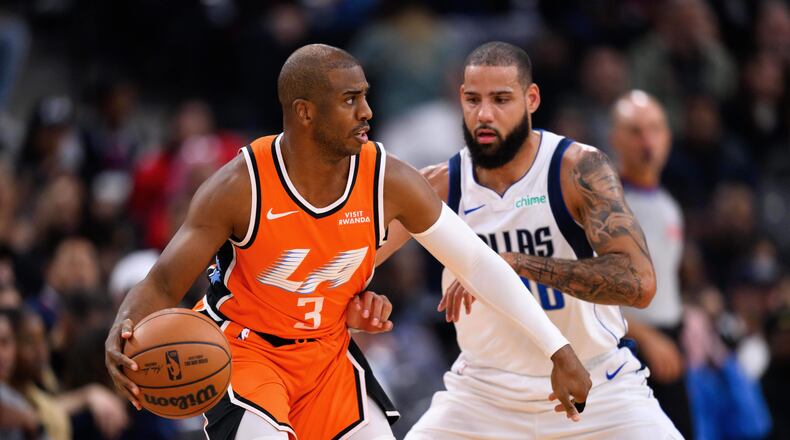 Los Angeles Clippers guard Chris Paul (3) controls the ball under pressure from Dallas Mavericks forward Caleb Martin during the first half of an NBA basketball game Saturday, Nov. 29, 2025, in Inglewood, Calif. (AP Photo/William Liang)