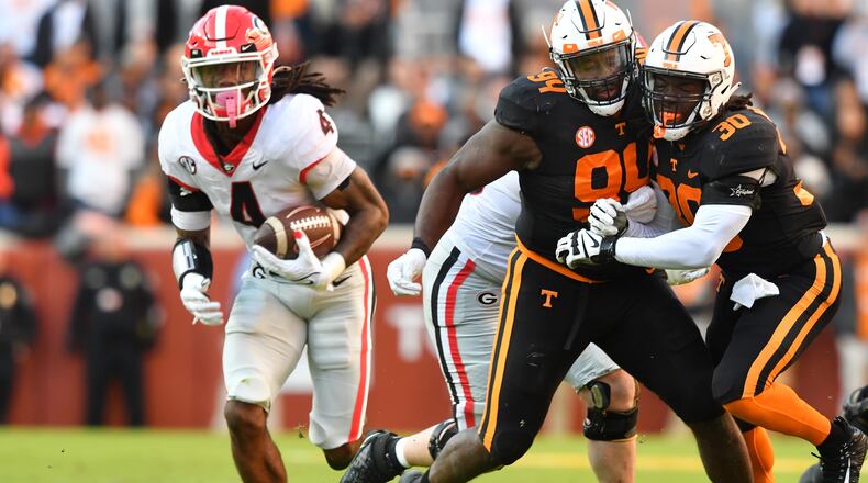 November 13, 2021 Knoxville, TN - Tennessee's defensive lineman Matthew Butler (94) and Tennessee's linebacker Roman Harrison (30) collide as Georgia's running back James Cook (4) runs for a touchdown in the first half during a NCAA football game at Neyland Stadium in Knoxville on Saturday, November 13, 2021. (Hyosub Shin / Hyosub.Shin@ajc.com)