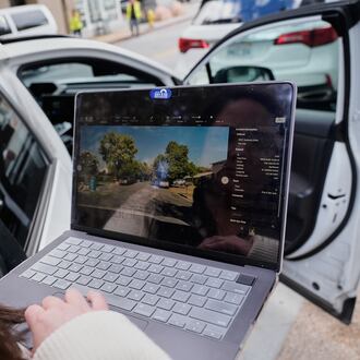 Chelsea Palacio, public information manager for the City of San Jose, showcases how a small detection camera uses AI to detect road hazards and potholes, in San Jose, Calif., Wednesday, Nov. 12, 2025. (AP Photo/Godofredo A. Vásquez)