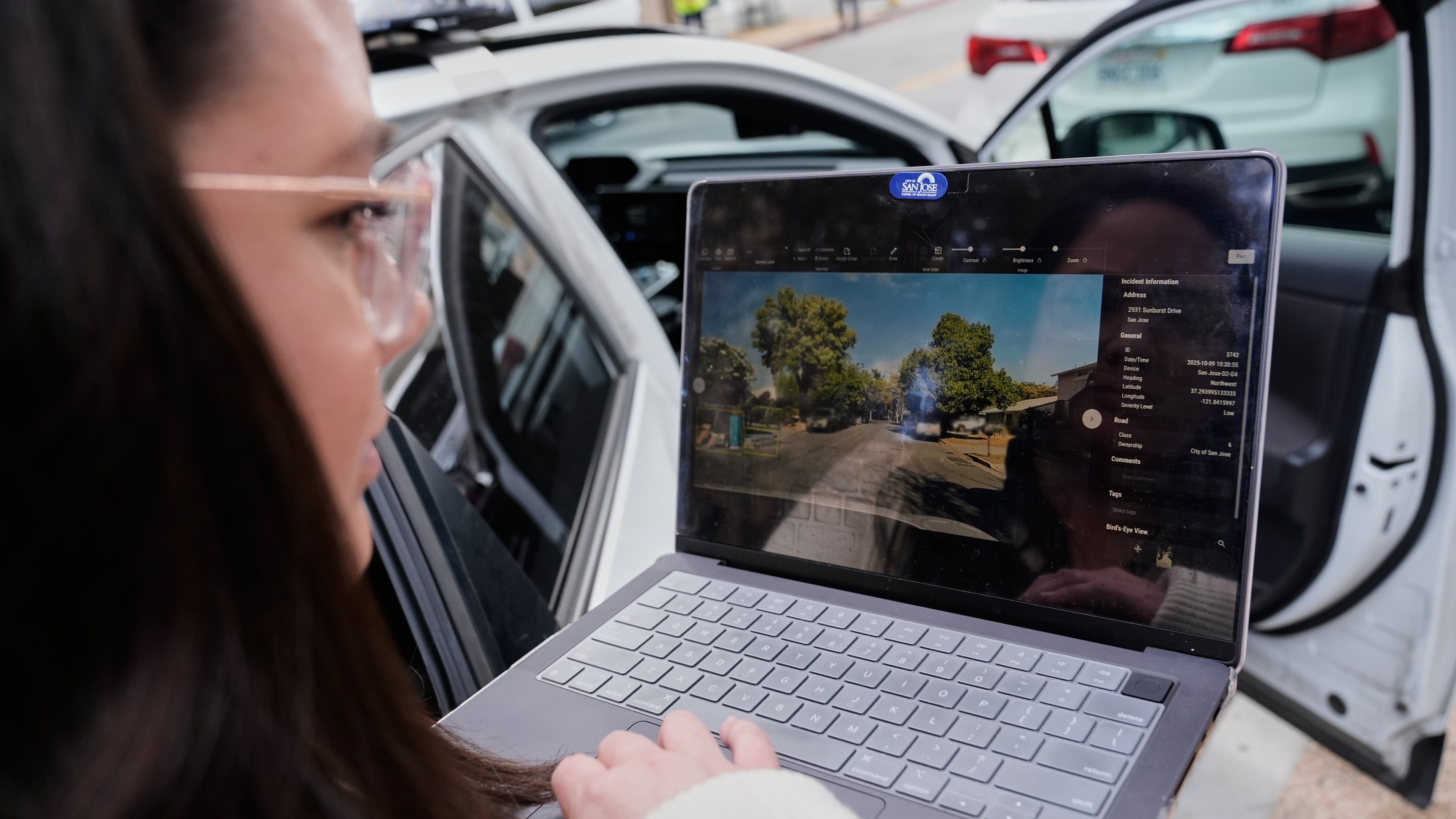 Chelsea Palacio, public information manager for the City of San Jose, showcases how a small detection camera uses AI to detect road hazards and potholes, in San Jose, Calif., Wednesday, Nov. 12, 2025. (AP Photo/Godofredo A. Vásquez)