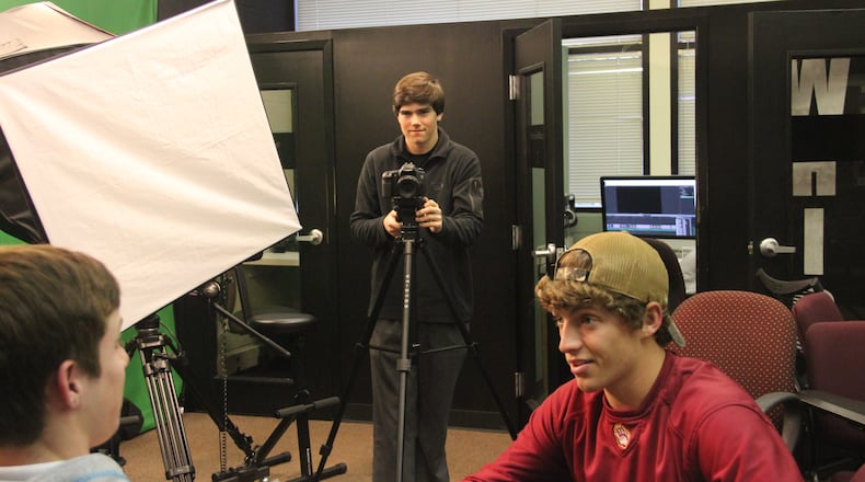 Holy Innocents' junior Clay Milling works on his Upper School Film Fest project with classmates Andrew Coggins (left) and Corbin Bailey (in red hat).