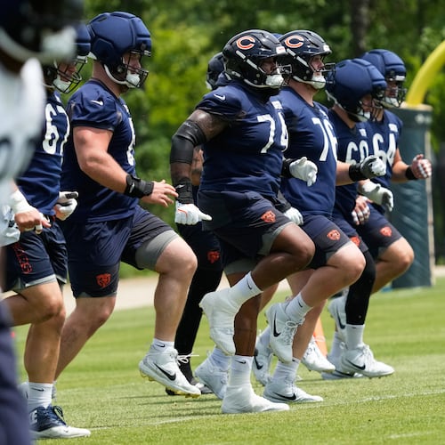 Chicago Bears offensive linemen warm up during the NFL football team's practice Wednesday, June 3, 2026, in Lake Forest, Ill. (AP Photo/Nam Y. Huh)
