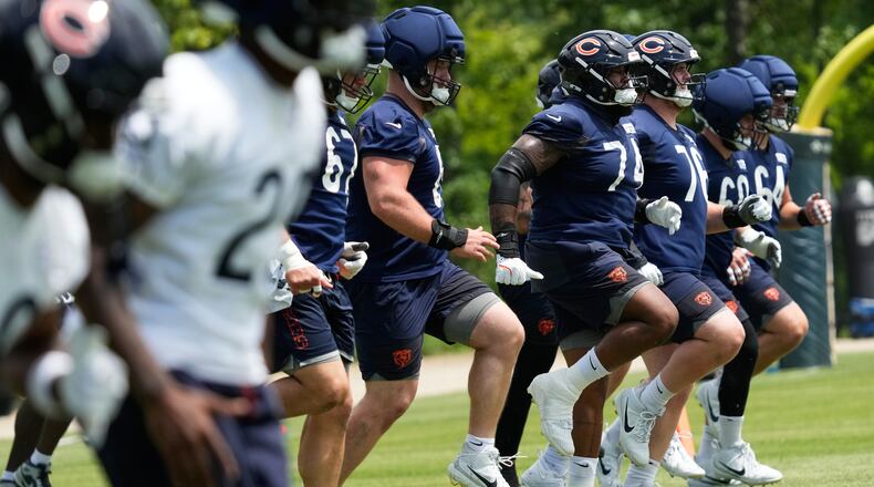 Chicago Bears offensive linemen warm up during the NFL football team's practice Wednesday, June 3, 2026, in Lake Forest, Ill. (AP Photo/Nam Y. Huh)