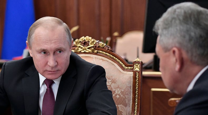 Russian President Vladimir Putin, left, speaks to Defense Minister Sergei Shoigu during a meeting in the Kremlin in Moscow, Russia, Saturday, Feb. 2, 2019. Putin said that Russia will abandon the 1987 Intermediate-Range Nuclear Forces treaty, following in the footsteps of the United States, but noted that Moscow will only deploy intermediate-range nuclear missiles if Washington does so. (Alexei Nikolsky, Sputnik, Kremlin Pool Photo via AP)