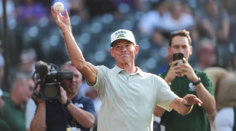 Colorado State University football head coach Jim Mora warms up before throwing the ceremonial first pitch before the Colorado Rockies host the Kansas City Royals in the first inning of a baseball game Saturday, Aug. 1, 2026, in Denver. (AP Photo/David Zalubowski)