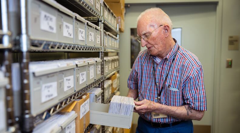 Guy "Mac" McGowan, 96, sorts through voter registration cards as he helps maintain Muskogee County's voter registration lists in Columbus. (Nathan Posner for The Atlanta Journal-Constitution)