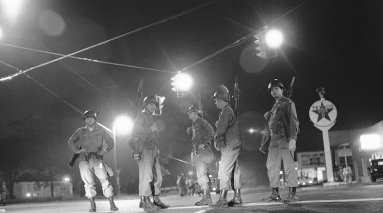 Georgia National Guard troops an intersection at the edge of the riot-torn area of town in Augusta, Ga., May 12, 1970. The guardsmen were called to duty when roving gangs began to riot, setting fire to over fifty buildings and looting many stores. (AP Photo/Joe Holloway, Jr.)