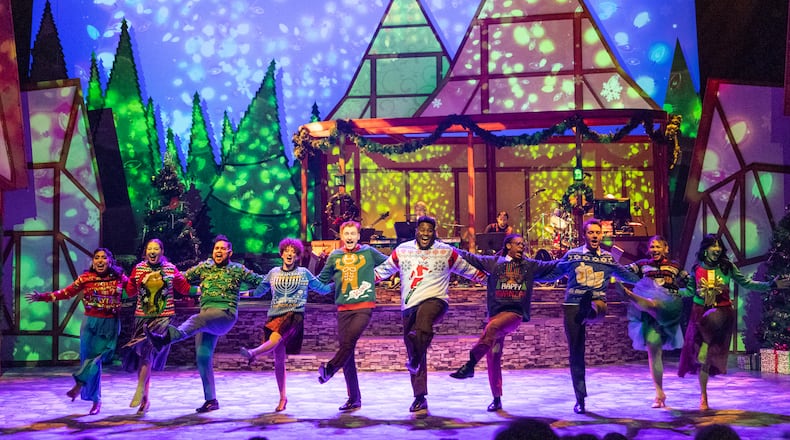 The full cast of “Christmas Canteen” dances wearing holiday sweaters.