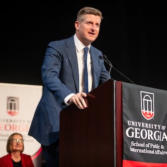 AJC chief political reporter Greg Bluestein delivers the convocation address at the University of Georgia's School of Public and International Affairs on May 8, 2026. (Justin Evans for the AJC)