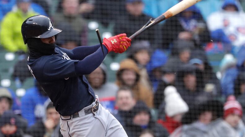 Ozzie Albies breaks his bat hitting an RBI double against the Cubs on Saturday. (AP Photo/Nam Y. Huh)