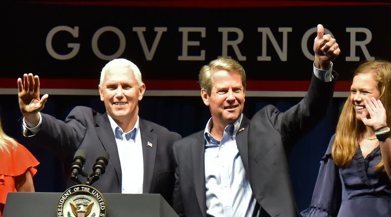 November 1, 2018 Dalton - Vice President Mike Pence and GOP gubernatorial candidate Brian Kemp wave to supporters at Dalton Convention Center in Dalton on Thursday, November 1, 2018. The nationally-watched Georgia race for governor is about to get even more attention. Vice President Mike Pence is headed to Georgia on Thursday for a trio of events in conservative areas for Brian Kemp. Democrats are countering with a visit by Oprah Winfrey, who will appear with Stacey Abrams at a pair of town hall meetings. HYOSUB SHIN / HSHIN@AJC.COM
