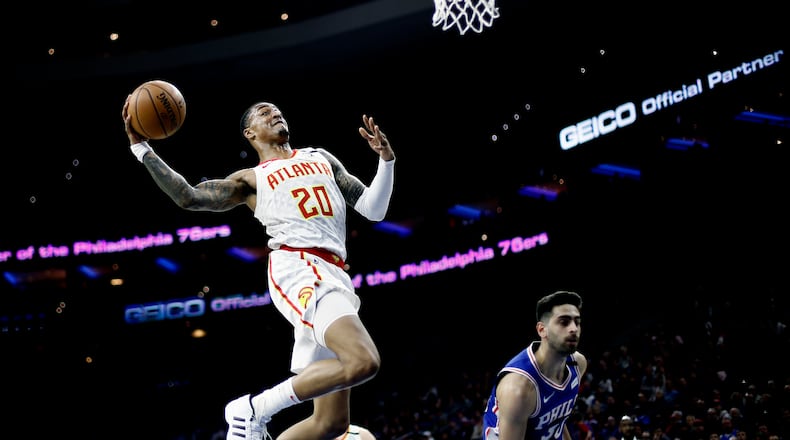 Atlanta's John Collins goes up for a dunk against Furkan Korkmaz of the Sixers during the first half of Monday's game in Philadelphia. (AP Photo/Matt Slocum)