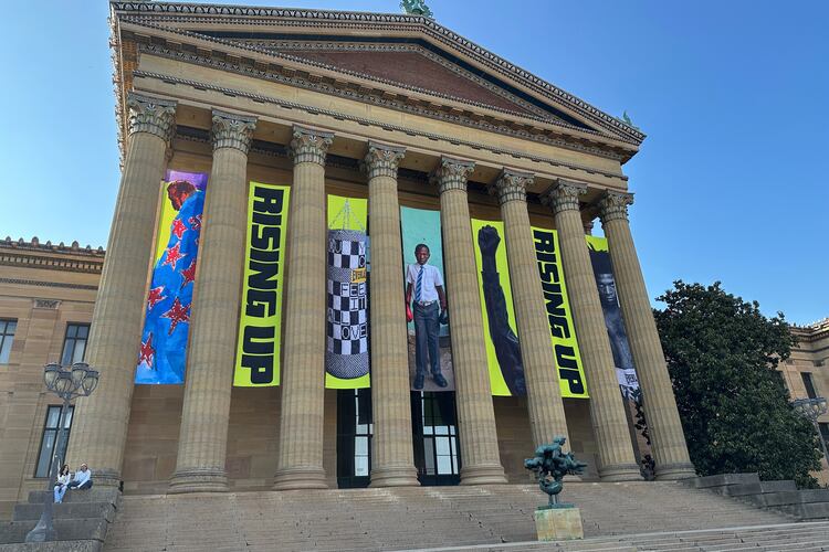 Banners for the "Rising Up: Rocky" exhibition hang outside of the Philadelphia Museum of Art in Philadelphia, Wednesday, April 22, 2026. (AP Photo/Tassanee Vejpongsa)