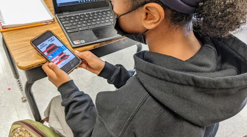 Mackenzie Smith of Wesley Academy pulls up her copy of "Stamped," a book about racial issues she read with her eighth-grade classmates.