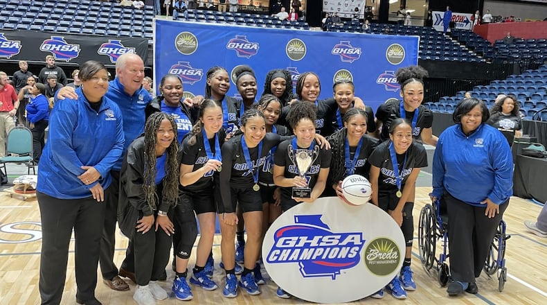 Mount Paran Christian players and coaches celebrate their 67-44 victory over Banks County in the Class 2A girls basketball championship game at the Macon Coliseum on March 9, 2023.
