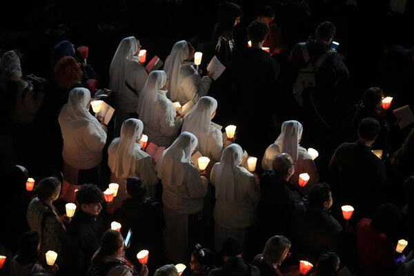 Nuns attend the procession outside the Colosseum during the Via Crucis (Latin for 'way of the cross') in Rome, Friday, April 18, 2025. (AP Photo/Andrew Medichini)