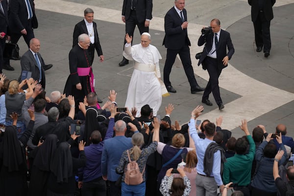 Pope Leo XIV waves at the end of his first weekly general audience in St. Peter's Square at The Vatican, Wednesday, May 21, 2025. (AP Photo/Alessandra Tarantino)