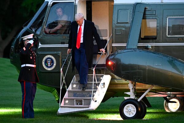President Donald Trump arrives on the South Lawn of the White House, Thursday, May 22, 2025, in Washington, after attend a crypto dinner at Trump National Golf Club Washington DC. (AP Photo/John McDonnell)