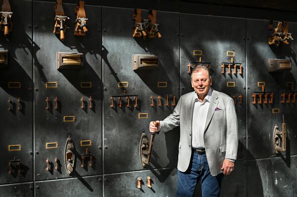 Richard C. Kessler pulling a switch on the original flip-board station of the former power plant that now houses his JW Marriott hotel development at Plant Riverside District in Savannah, Georgia. (Sarah Peacock for The Atlanta Journal-Constitution)