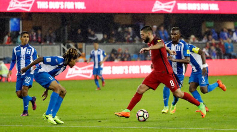 United States' Clint Dempsey, in red, dribbles next to a group of Honduras defenders during the second half of a World Cup qualifying soccer match Friday, March 24, 2017, in San Jose, Calif. The United States won 6-0. (AP Photo/Marcio Jose Sanchez)