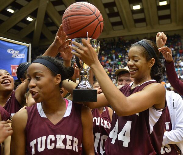 Tucker's Erykah Davenport (44) holds the game ball and championship trophy during the awards ceremony after their Class AAAAA title win over Southwest Dekalb Friday, March 7, 2014, in Macon. (Kent D. Johnson / AJC)